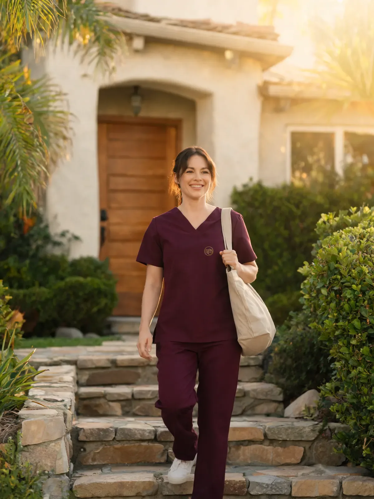 A caregiver arrives at the front steps in golden evening light