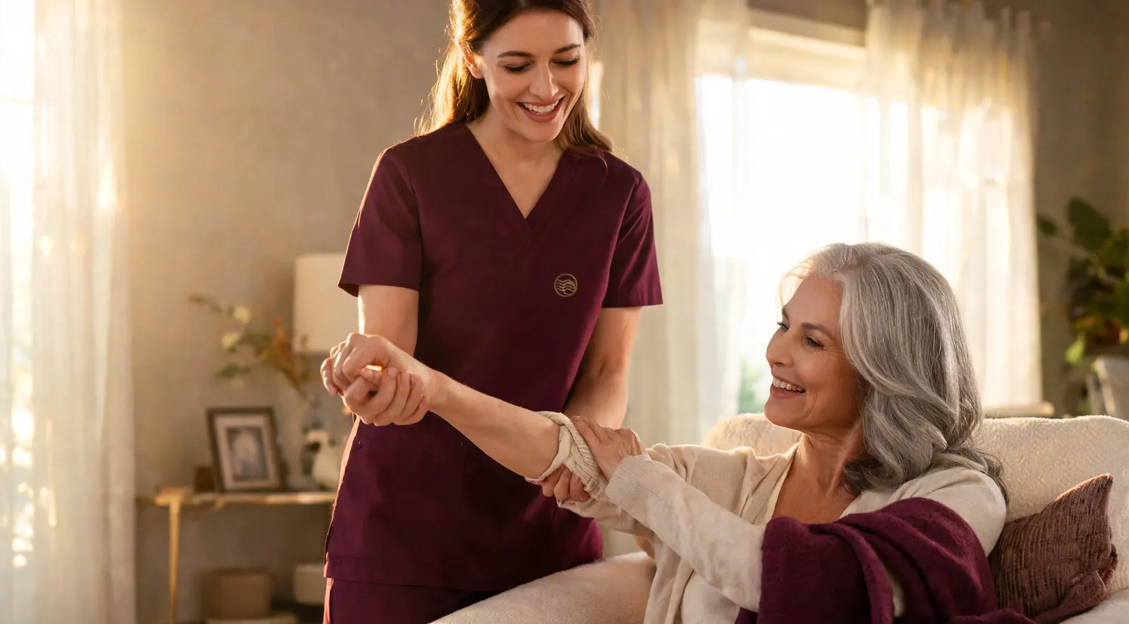 A smiling therapist works face to face with an older woman during a session at home